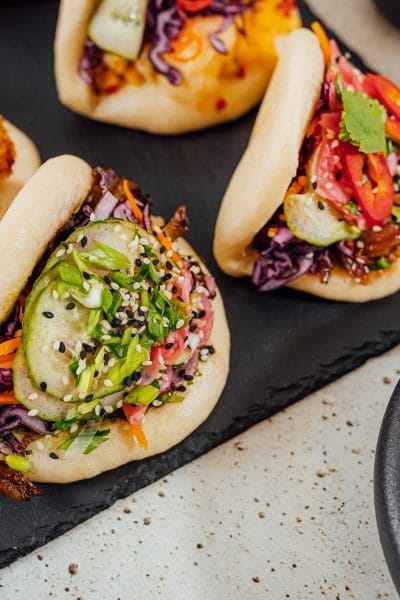 Closeup shot of steamed bao buns on a black surface