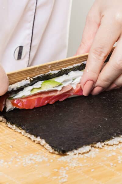 Chef prepares rolls, hands closeup