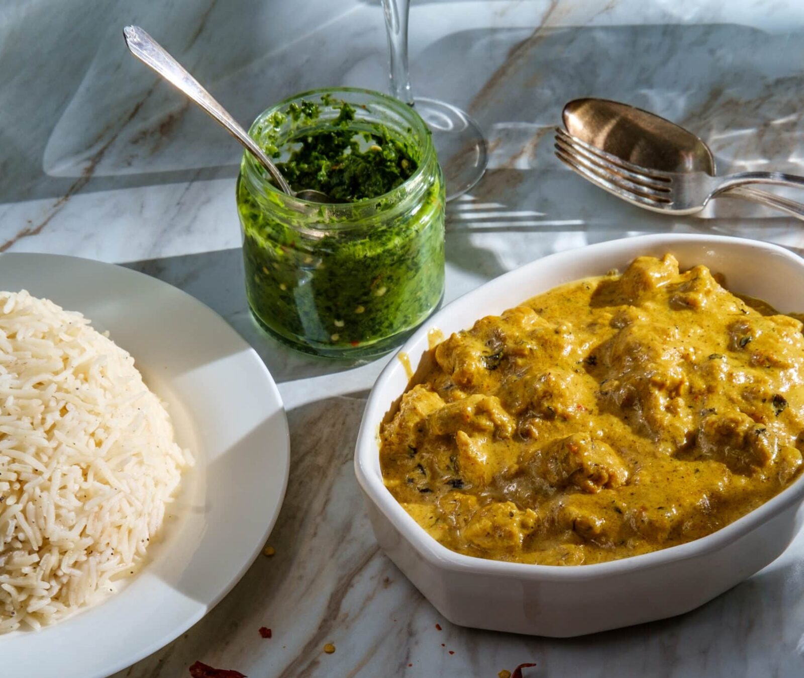 Authentic Indian almond chicken korma curry dinner with basmati rice and green chutney
