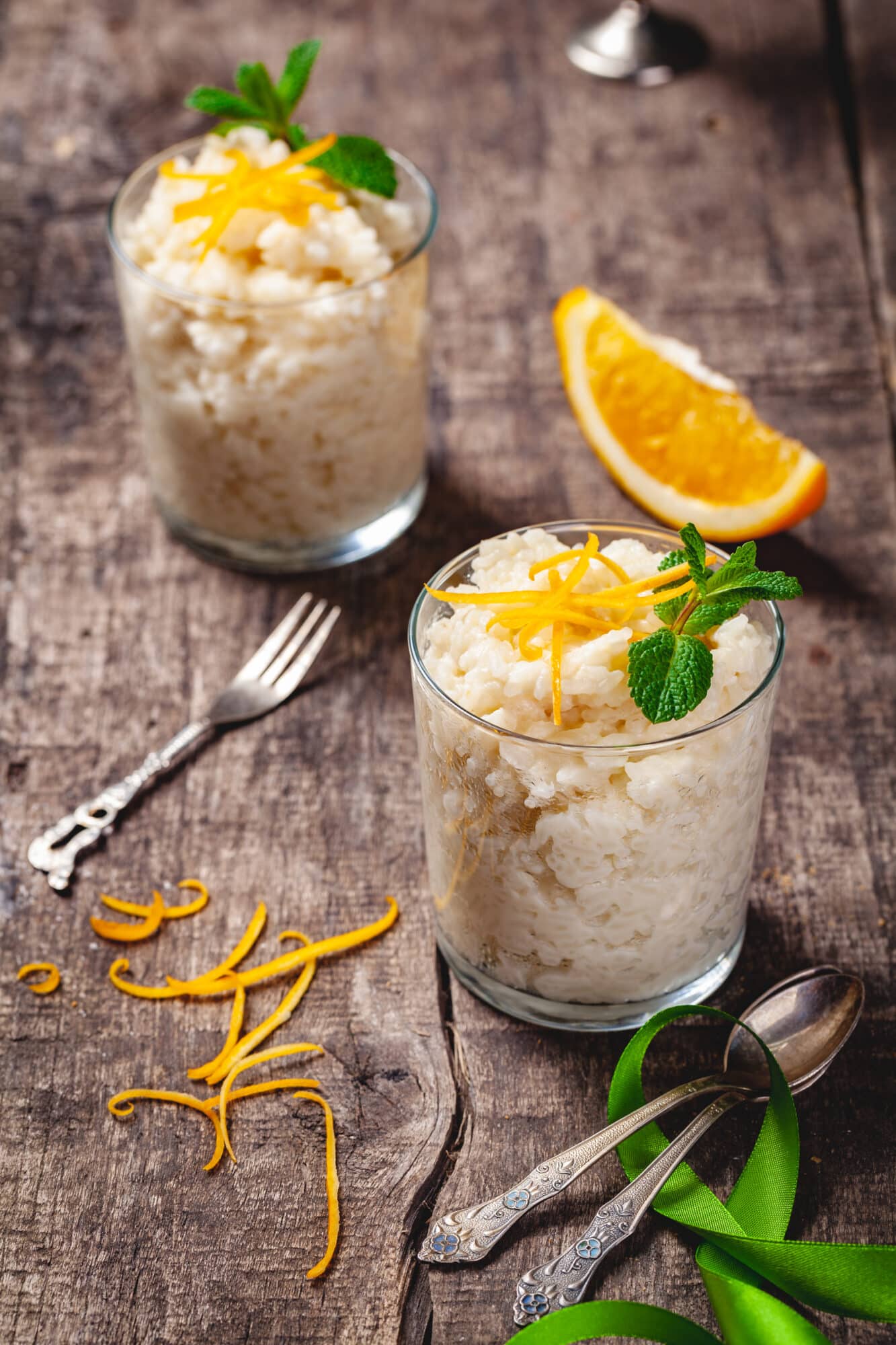 Two glasses of rice pudding on wooden rustic table. Close up. Two glasses of rice pudding on wooden rustic table. Close up