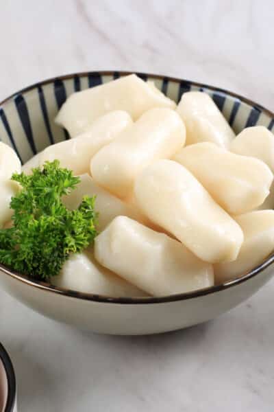 Close Up Garaetteok Korean Bar Rice Cake Stick of Rounded Rice Cake with Mozarella Cheese Inside.