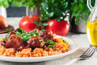 Meatballs with tomato sauce and red rice. Spanish and Mexican dish